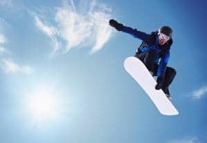 A snowboarder flying through the air.