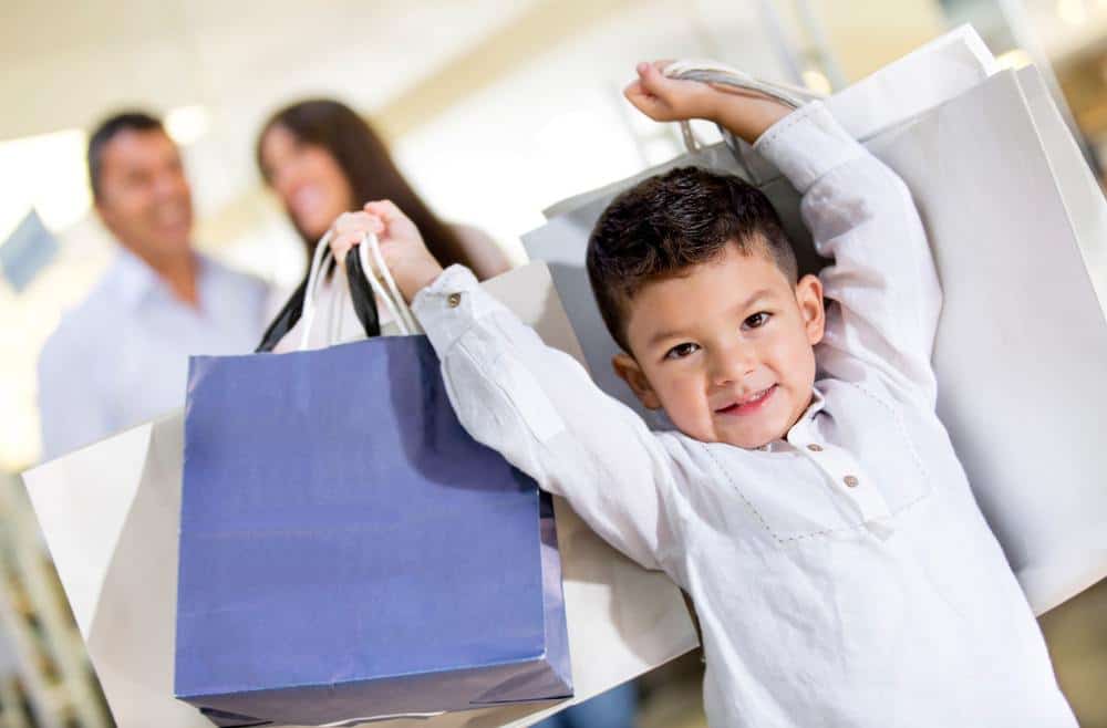 Little boy carrying bags from shopping
